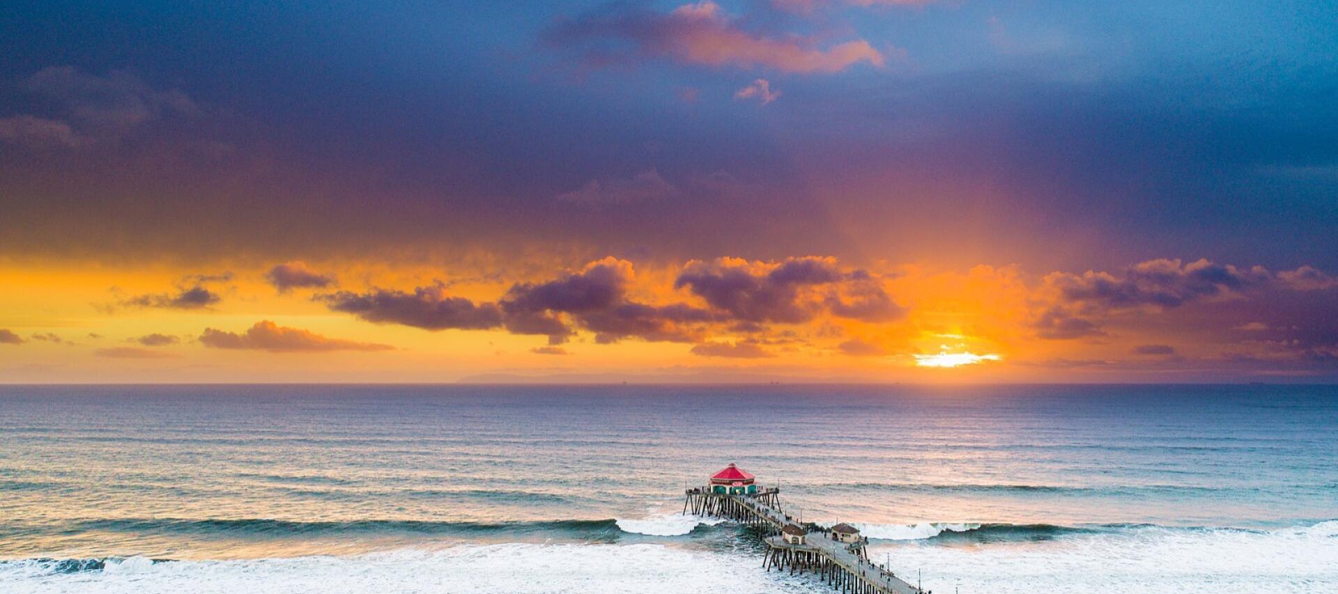 Huntington Beach Pier at sunset, seen from above the surf