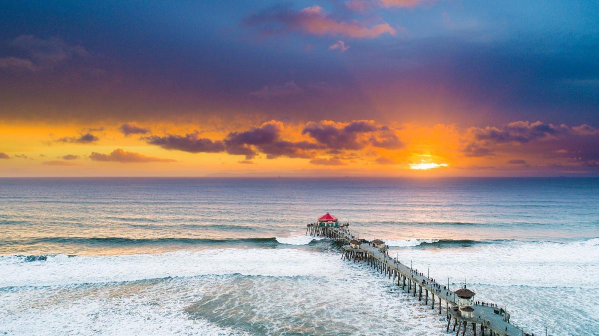 Huntington Beach Pier at sunset, seen from above the surf
