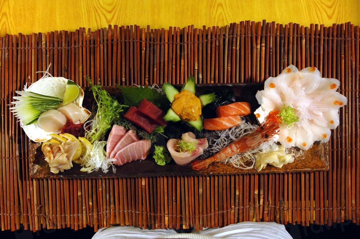 Omakase sashimi dinner spread on a dark stone platter